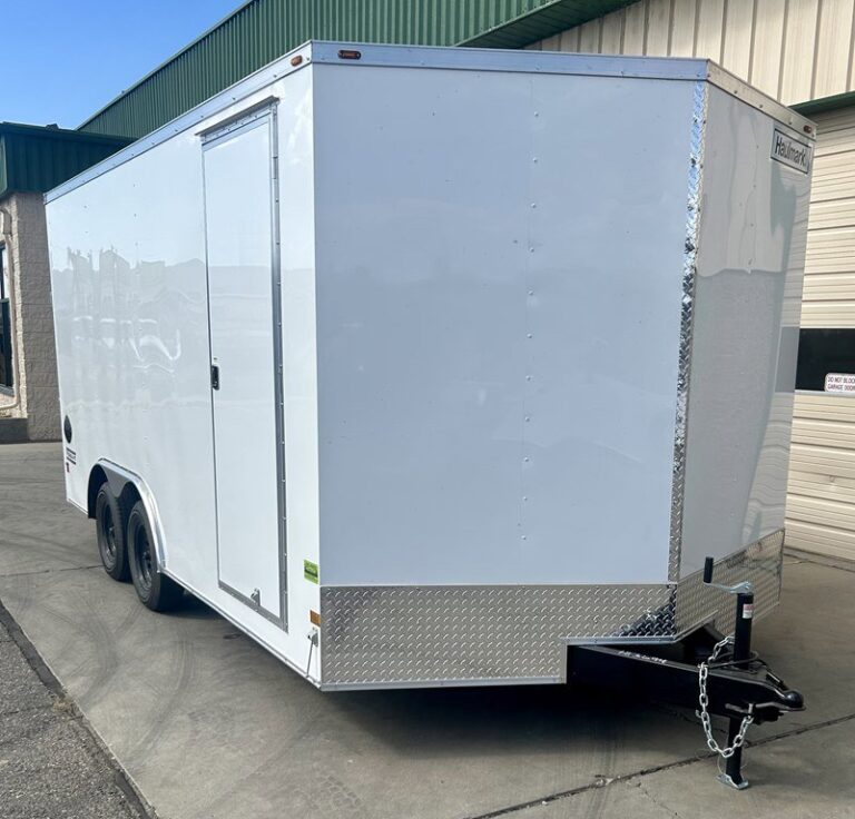White enclosed trailer with diamond plate trim, single axle, and side door parked on concrete